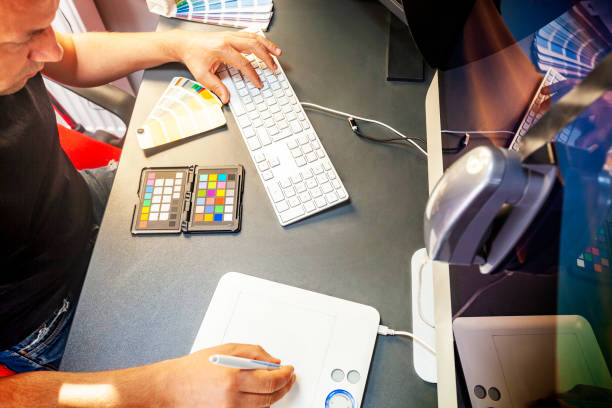 Professional computer graphic designer calibrates the computer monitor