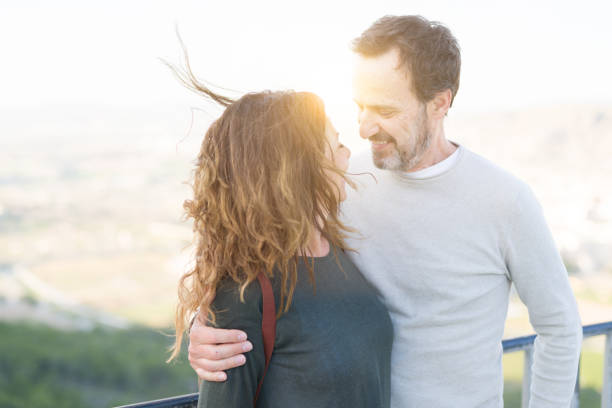 istock Romantic couple smiling and cuddling looking at each other on a sunny day 1174138413
