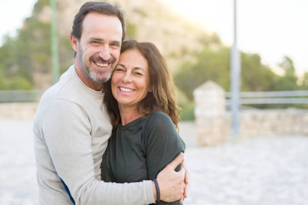 istock Romantic couple smiling and cuddling on a sunny day 1174138573