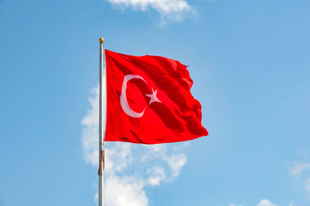 istock close up turkish flag at flagpole and blue sky with clouds. 1174138578