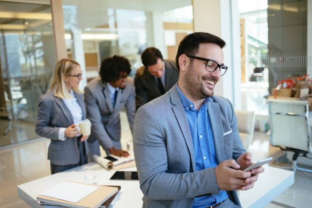 istock Young businessman using mobile phone in the office 1174139161