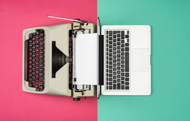 Classic analog typewriter vs Modern digital hi-tech laptop computer Modern Laptop Computer with Antique Typewriter analog stock pictures, royalty-free photos & images