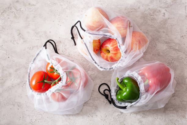 istock apples tomatoes bell peppers vegetables in reusable mesh nylon bag, plastic free zero waste concept 1174140718