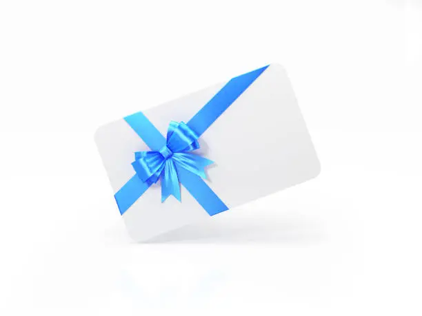 White gift card with blue bow tie on white background. Horizontal composition with and copy space.