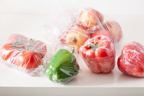 istock single use plastic packaging issue. peppers tomatoes apples vegetables in plastic bags 1174144706