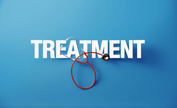Red stethoscope and treatment text on blue background. Health concept. Horizontal composition with copy space. Directly above. Health concept.
