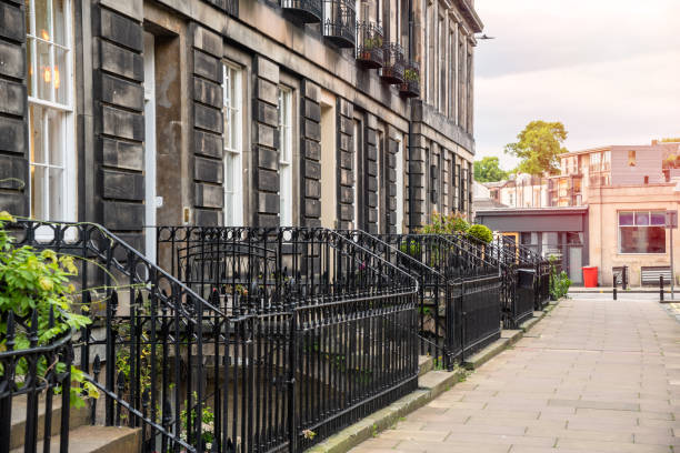 istock Old Terraced houses along a pavement at sunset 1174149548