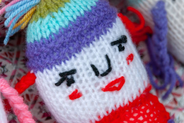 Wool Knitting Baby toy head closeup view. background.