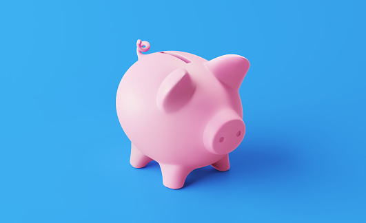 Piggy bank standing on blue background. Horizontal composition with copy space. Great use for savings concepts.