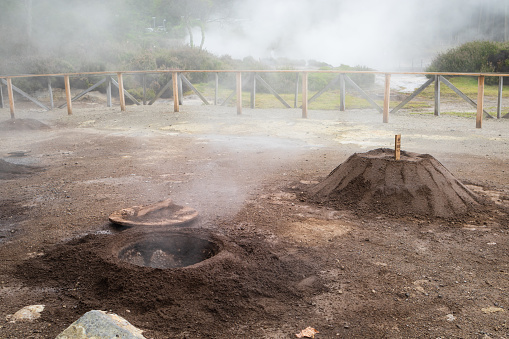Geothermal cooking - a hole where traditional meal Cozido das Furnas is cooked slowly in a hot spring by volcanic steam in Furnas on Sao Miguel, Azores, Portugal
