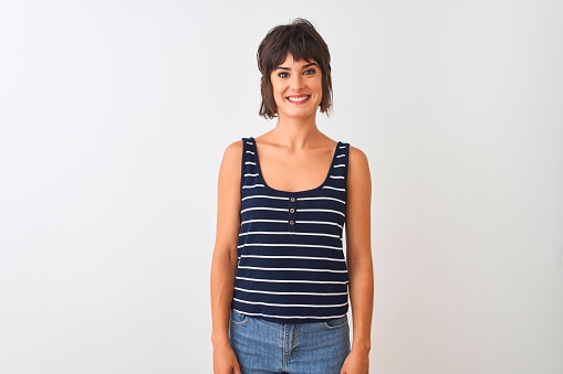 Young beautiful woman wearing striped t-shirt standing over isolated white background with a happy and cool smile on face. Lucky person.