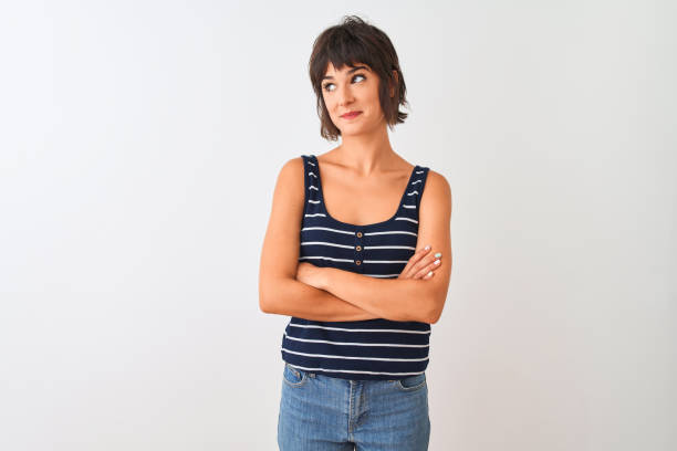 young beautiful woman wearing striped t-shirt standing over isolated white background smiling looking to the side and staring away thinking. - mannered imagens e fotografias de stock