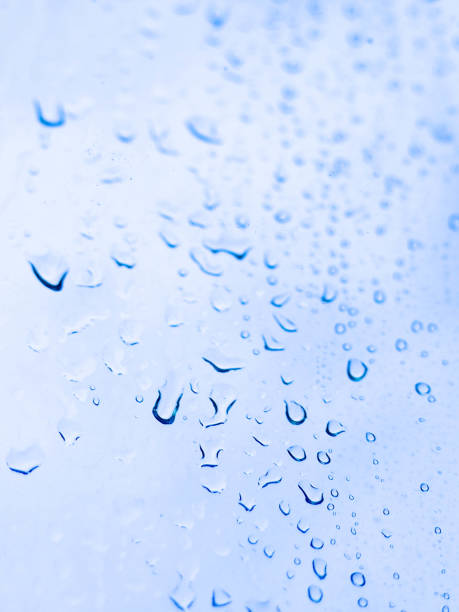 istock Rain drops or water drops at the window.Rain drooping on window surface with blurred background of the green of the outside garden. 1174162544