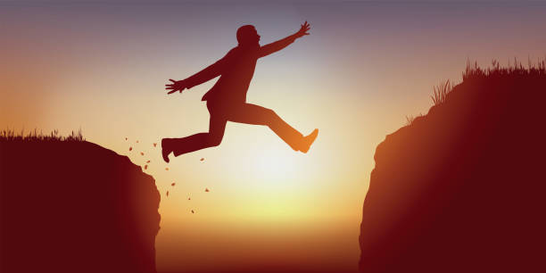istock An ambitious man risks his life by jumping over a chasm to reach the other bank. 1174165165