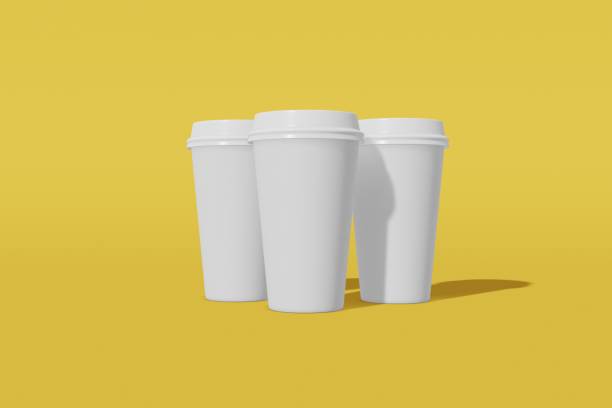 istock Set of three white paper mockup cup with a lid on a yellow background. 3D rendering 1174165621