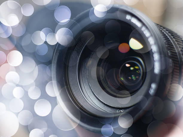 istock lens digital camera, selective focus, close-up, side with reflection, bokeh, isolated on white background 1174165731