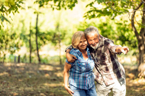 istock Senior couple walking in park 1174168766