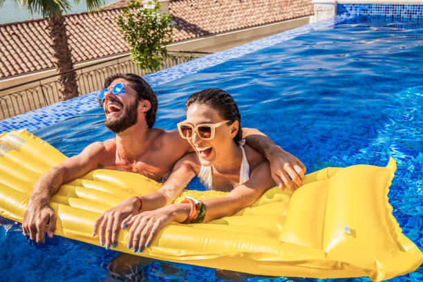 istock young couple have fun in a pool 1174170111