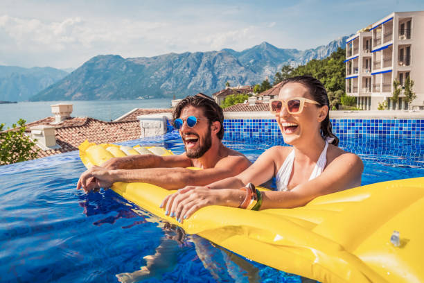istock young couple have fun in a pool 1174170120