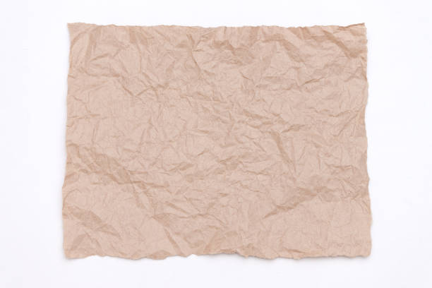 istock Abstract part of packaging craft wrinkled paper on white background. 1174170124