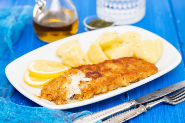 istock fried fillet of fish with boiled potato on white dish 1174172089