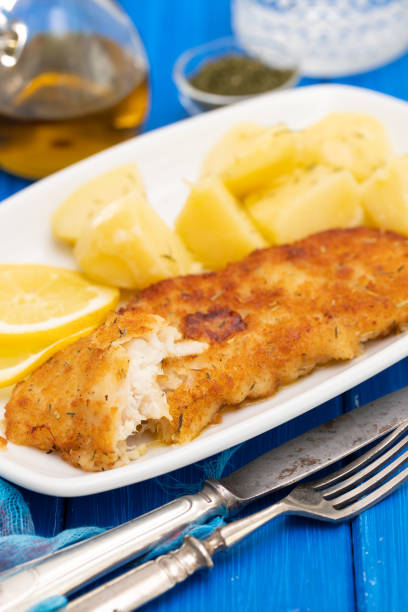 istock fried fillet of fish with boiled potato on white dish 1174172105