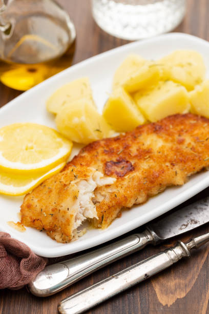 istock fried fillet of fish with boiled potato on white dish 1174172117