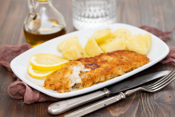 istock fried fillet of fish with boiled potato on white dish 1174172124