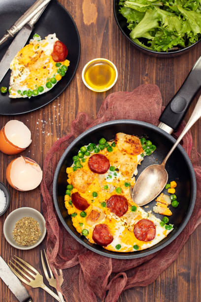 istock mixed egg with potato, peas and smoked sausages 1174172256