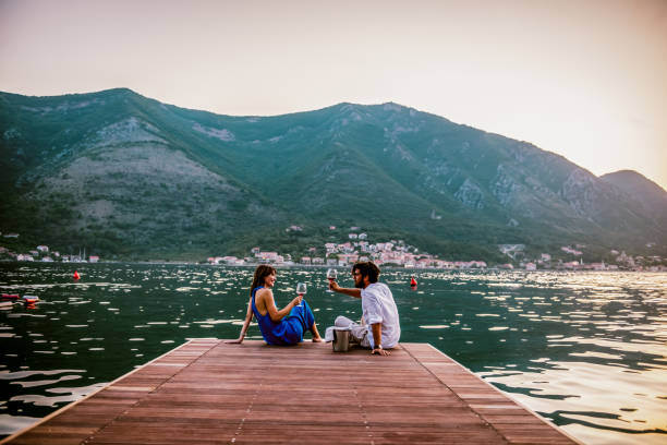 Romantic sunset by the sea couple in love drink wine during romantic dinner by the sea honeymoon stock pictures, royalty-free photos & images