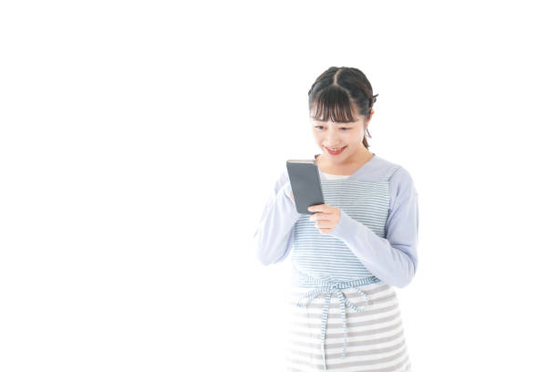 istock Young housewife using smart phone with a smile 1174176547