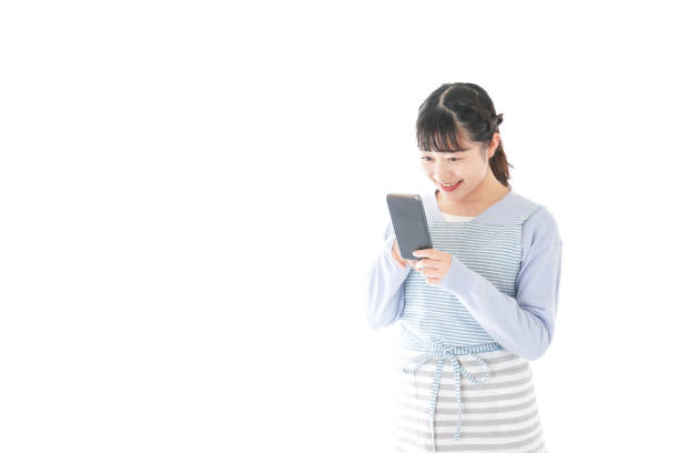 istock Young housewife using smart phone with a smile 1174176627