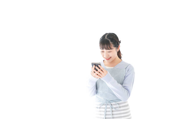 istock Young housewife using smart phone with a smile 1174176663
