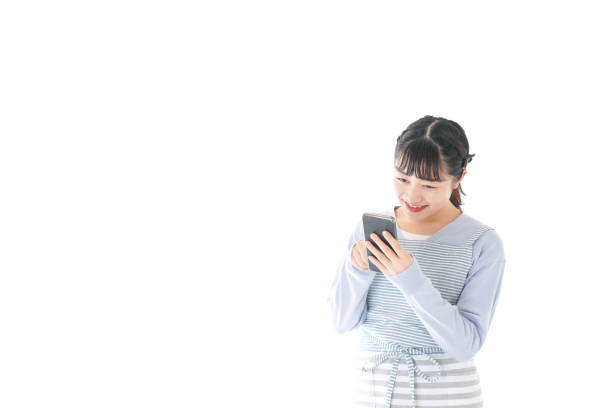 istock Young housewife using smart phone with a smile 1174176696