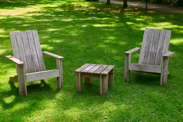 istock Wooden chairs and table in the meadow 1174181706