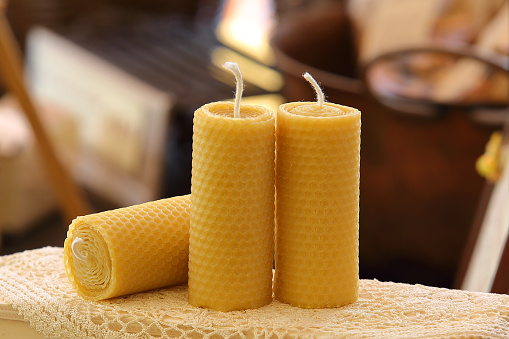 Artisanal candles extinguished in wax honeycombs with warm background in shades of brown