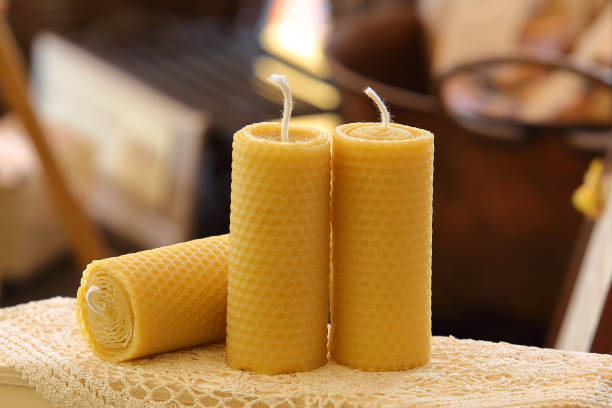 Candles with pattern in the shape of beeswax alveoli Artisanal candles extinguished in wax honeycombs with warm background in shades of brown beeswax photos stock pictures, royalty-free photos & images