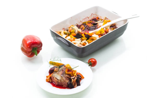 fish stew with beets and other vegetables in a plate, isolated on white background