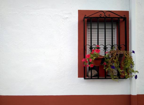 istock Window with colorful bars and pots 1174193432
