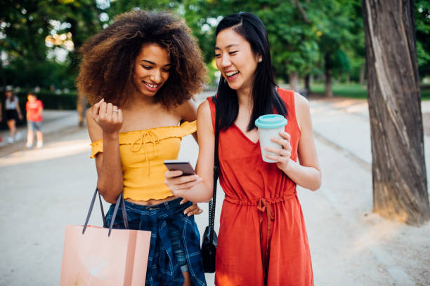 istock Mixed race girls walking through park 1174193727