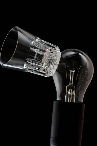 istock Incandescent lamp on a black background, the spiral breaks and the lamp itself 1174207201