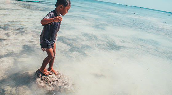 Little kid having fun in the sea