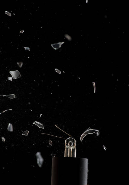 istock Incandescent lamp on a black background, the spiral breaks and the lamp itself 1174207380