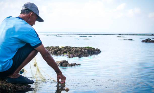 istock Old fisherman preparing for fishing 1174207437
