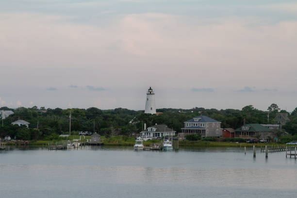 Silver Lake Harbor, Ocracoke Island, Outer Banks, North Carolina Ocracoke lighthouse on a  cloudy, overcast day on the sea ocracoke lighthouse stock pictures, royalty-free photos & images
