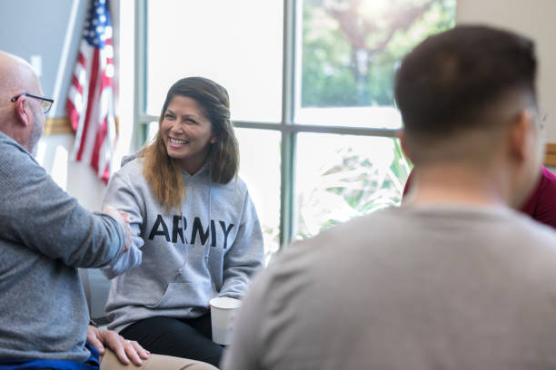 istock Therapist greets newest group member with handshake 1174210588