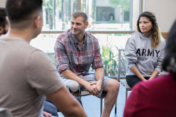 istock Members of veterans support group look at unseen person 1174210619
