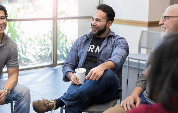 istock Members of veteran's support group share laugh in meeting 1174210620