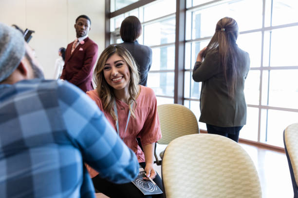 istock Cheerful woman greets man during conference 1174211247