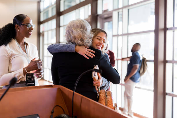 istock Women embrace before conference or seminar 1174211793